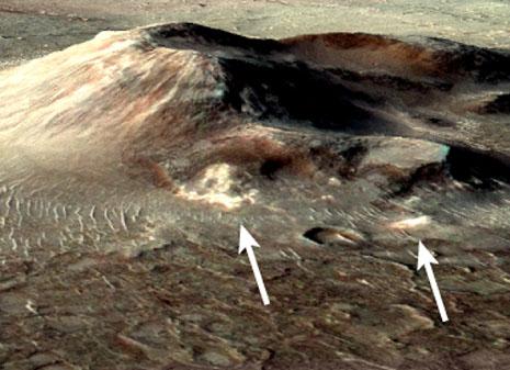 Warm, wet spots - Volcanic deposits on Mars may preserve evidence of one of the planet’s most recent habitable microenvironments. The deposits, shown in white (arrows), are located in Nili Patera, a degraded volcanic cone in Syrtis Major of equatorial Mars.