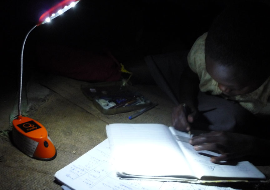 ‘You will learn from and others will learn from you.’: Chishio Furukawa, a 2011 BISP fellow, studied how replacing kerosene lamps with solar-powered lights might benefit people like this student in Uganda. Credit:&nbsp;Chishio&nbsp;Furukawa/Brown University