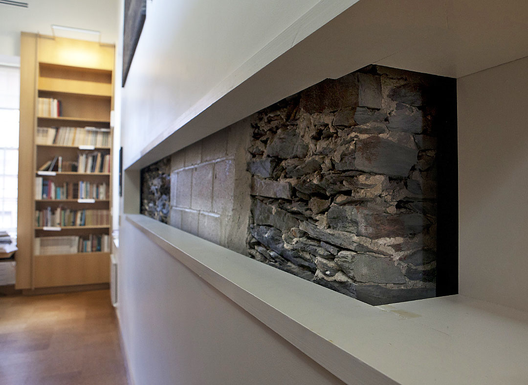All about preservation: Architects left a portion of the original 1840 field stone wall exposed to give visitors to the Joukowsky Institute a glimpse of architectural history.