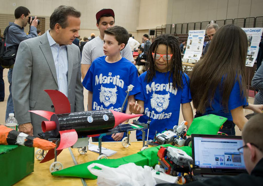 When robots meet kids with imagination: Rep. David Cicilline checks out some of the robotic devices built by schoolkids. Among the projects on display Saturday: a Lego snake that lunges at whatever moves into its visual sensor field and a robotic dogsled.