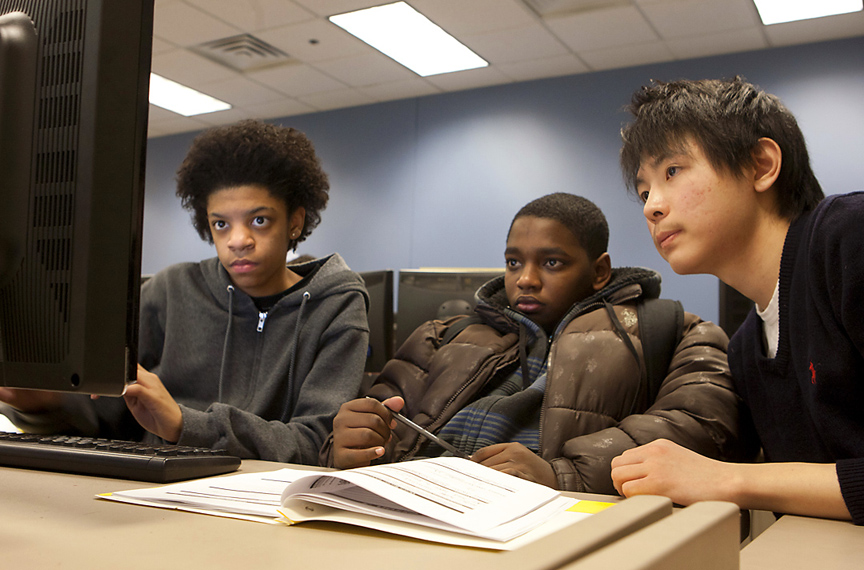 Focused on programming, unfazed by algebra: Kidai Kwon, right, works with middle-school students Devante King, left, and Wesley Cabral during an after-school Bootstrap session.&nbsp;&nbsp;&nbsp;Credit: Mike Cohea