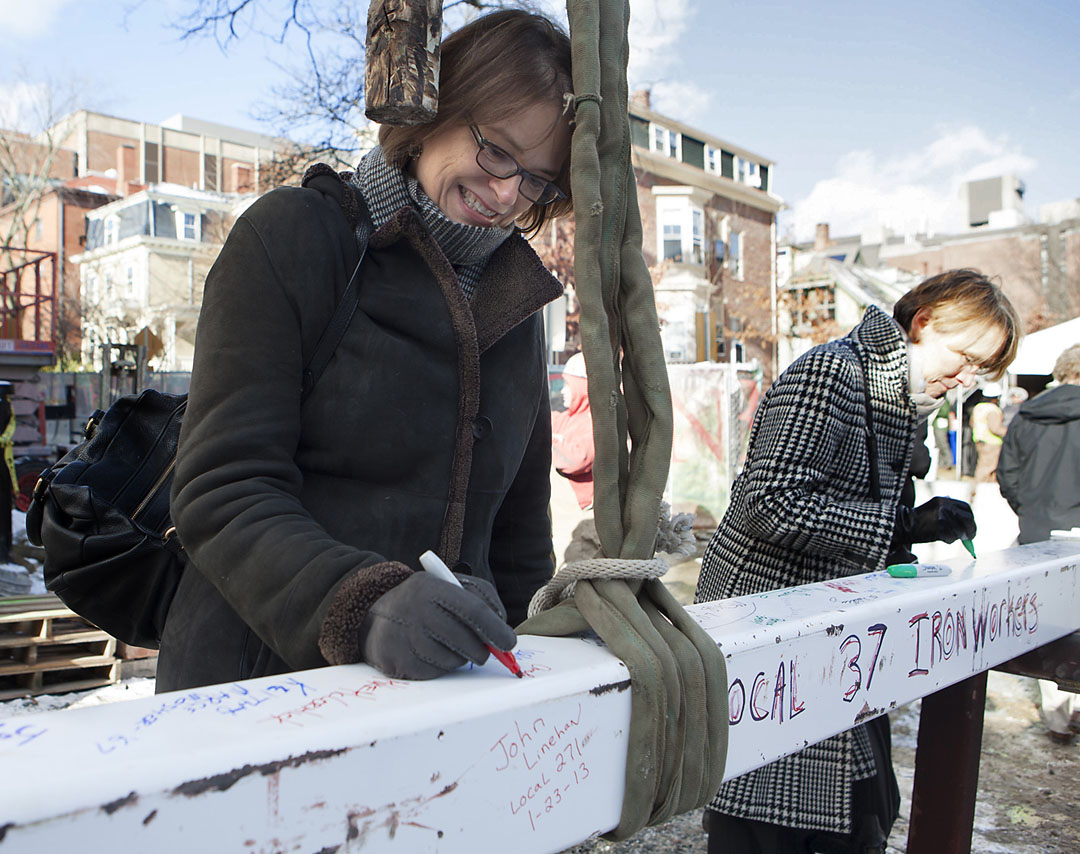 A happy, very cold day: President Paxson adds her signature to the final beam at the topping-off ceremony for the new environmental building. Photos&nbsp;by&nbsp;&nbsp;Mike&nbsp;Cohea/Brown&nbsp;University