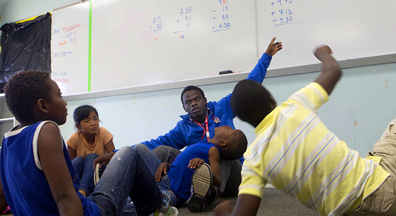 A chance to give back: Jean-Jacques Yves Sibomana, a Brown senior, arrived in the United States as a refugee from Rwanda. Many of the counselors have faced what their young charges are facing now.