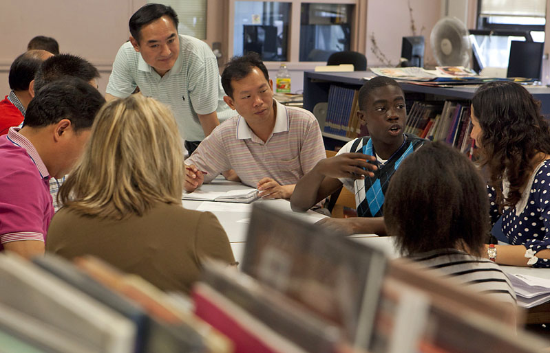 This is how we do it here: Esek Hopkins eighth-grader Komotay Koffie, 14, answers questions from visiting Chinese administrators and educators through a translator.Credit: Mike Cohea/Brown University