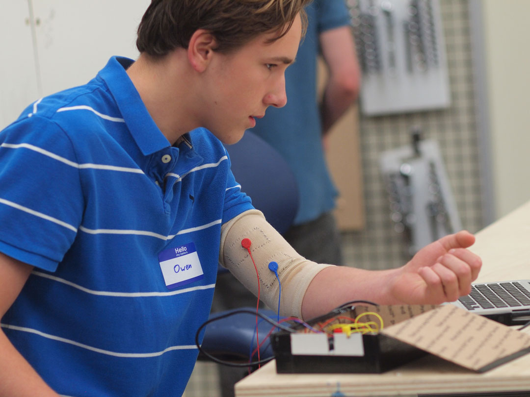 Flexing a communications muscle: Owen Duke, a 10th grader at Phillips Exeter Academy, has been perfecting a biceps cuff to detect intentional twitches. He and a Brown graduate student he met at the makeathon wrote code to translate a muscle twitch into a computer click.