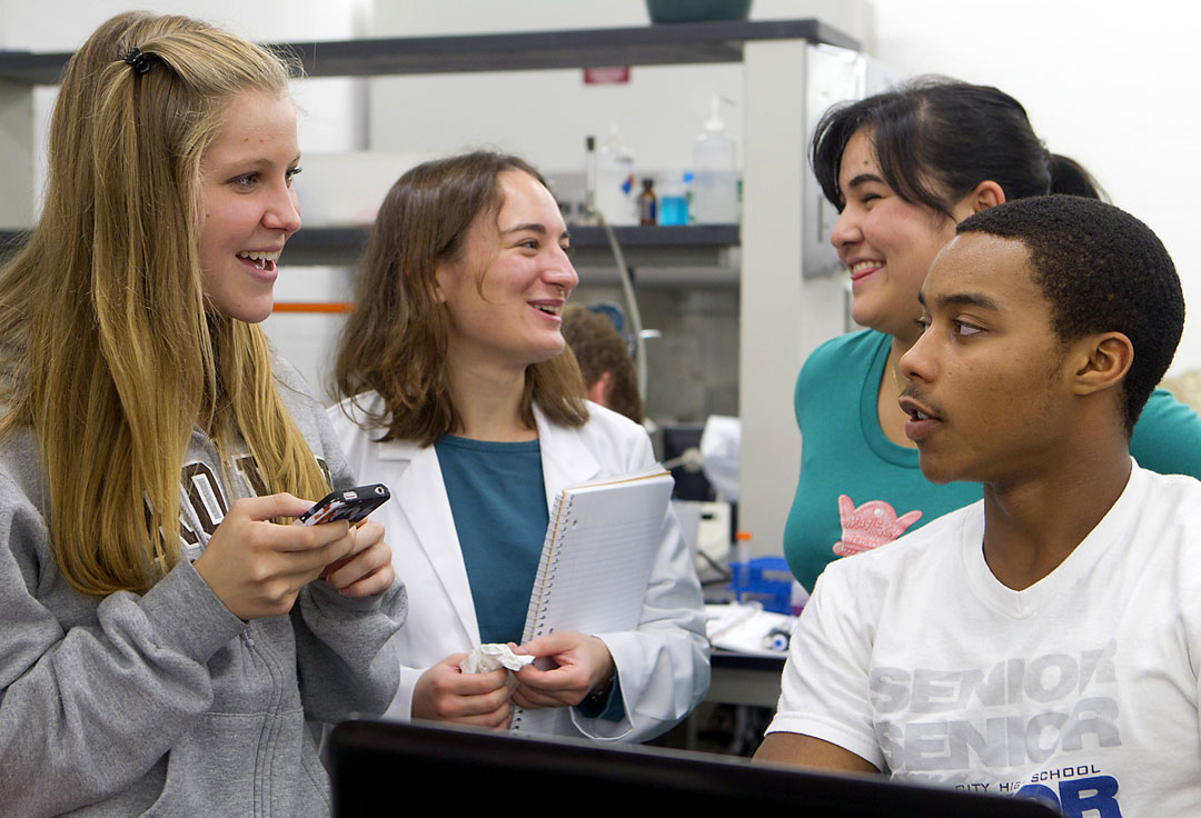 Hard work and viral Olympics: Lab partners Tina Voelcker and Anthony Cox, foreground, work on their virus Antina. Selen Senocak (Artemis) and Aisha Ferrazares (Virgil), rear, work on theirs. The winning virus gets a full sequencing between semesters.